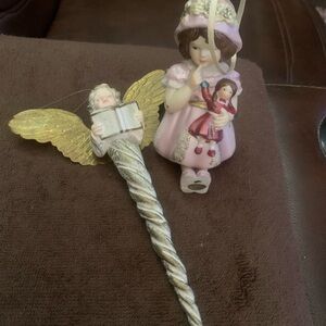 Vintage porcelain ornament of a girl holding a doll and a Dept 56 angel wand.